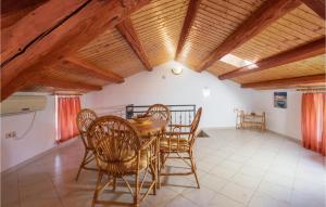 a dining room with a table and chairs and wooden ceilings at 4 Bedroom Lovely Home In Sveti Anton in Sveti Anton