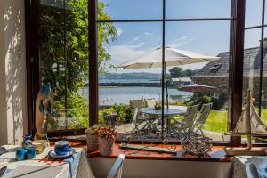 a dining room with a table and an umbrella at Seascape B&B in Union Hall