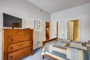 a bedroom with a bed and a dresser with a television on it at Pico C103 in Killington