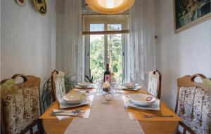 a dining room table with a bottle of wine on it at Amazing Apartment In Kraljevica in Kraljevica +12 photos