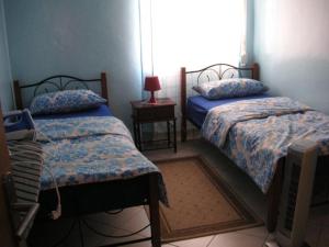 a bedroom with two beds and a window at Appartement Marhaba in Agadir