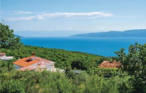 dwa domy na wzgórzu z oceanem w tle w obiekcie Holiday Home Labin 57 w mieście Drenje