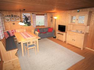 a living room with a table and a couch at Cosy Holiday Home in Egg near Ski Area in Egg