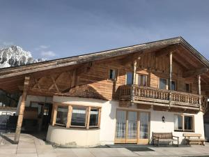 a log house with a balcony on top of it at Captivating Holiday Apartment in Ellmau in Ellmau