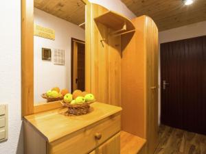 a bowl of fruit on a wooden cabinet in a room at Holiday apartment in Tauplitz with sauna in Tauplitz