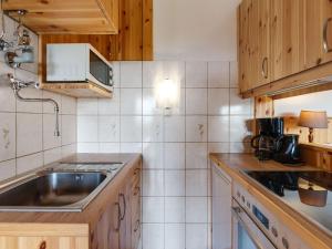 a kitchen with a sink and a counter top at Cosy holiday home with private pool in Eberstein