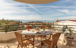 a patio with a table and chairs on a balcony at 2 Bedroom Beautiful Apartment In Makarska in Makarska