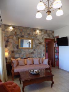 a living room with a couch and a table at Alkionides Villas in Xerokampos