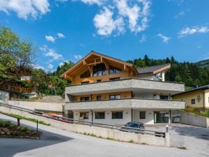 a house with a wooden roof on top of it at Apartment in St Johann im Pongau with sauna in Alpendorf
