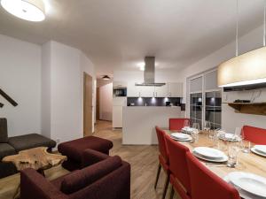 a dining room and kitchen with a table and chairs at Apartment in St Johann im Pongau with sauna in Alpendorf