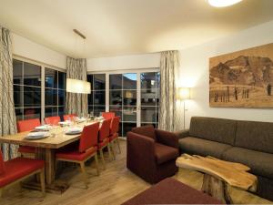 a dining room with a table and a couch at Apartment in St Johann im Pongau with sauna in Alpendorf
