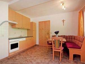a small kitchen with a table and a couch at Beautiful Apartment in Wagrain near Ski Area in Wagrain