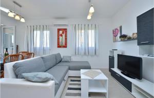 a living room with a couch and a tv at 2 Bedroom Gorgeous Apartment In Privlaka in Nin