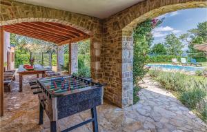 an outdoor entertaining area with a ping pong table at Holiday Home Juricev Kal I in Jurićev Kal