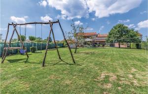 an empty swing set in a yard at Holiday Home Juricev Kal I in Jurićev Kal