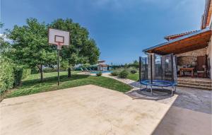 an outdoor basketball court with a basketball hoop at Holiday Home Juricev Kal I in Jurićev Kal
