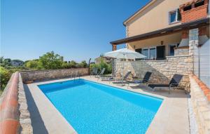 a swimming pool in front of a house at 3 Bedroom Stunning Home In Lovrecica in Lovrečica