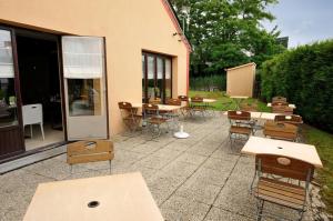 a patio with tables and chairs next to a building at Kyriad Direct Soissons in Soissons