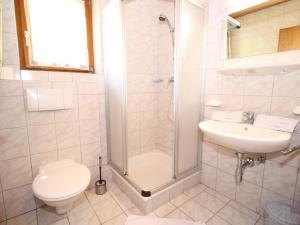 a bathroom with a shower and a toilet and a sink at Apartment in Wagrain near the ski area in Wagrain