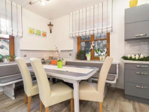 a kitchen with a white table and chairs at Large holiday home on the Katschberg in Carinthia in Rennweg