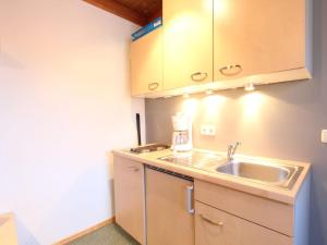 a small kitchen with a sink and a microwave at Lovely Apartment in Mittersill near Kitzb hel Kirchberg in Mittersill
