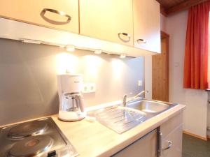 a kitchen with a sink and a coffee maker on a counter at Lovely Apartment in Mittersill near Kitzb hel Kirchberg in Mittersill