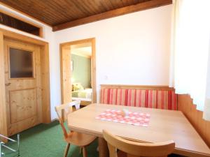 a dining room with a wooden table and chairs at Lovely Apartment in Mittersill near Kitzb hel Kirchberg in Mittersill