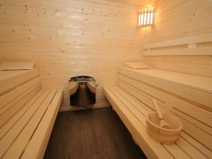 a sauna with two benches and a stove in it at Charming Chalet near Gro arl with Garden in Grossarl