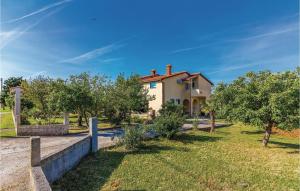 a house in a field with trees in front of it at Gorgeous Apartment In Barban-rebici With Kitchen in Rebići