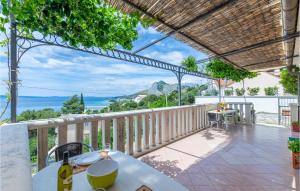 a balcony with a table and a view of the ocean at Cozy Apartment In Omis With House Sea View in Zakučac