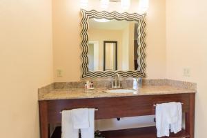 a bathroom with a sink and a mirror at Hotel Moab Downtown in Moab