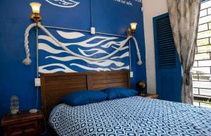 Postel nebo postele na pokoji v ubytování Chuchumbé Hotel & Hostal