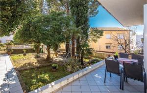 a patio with a table and chairs and trees at Gorgeous Home In Selce With Wifi in Selce