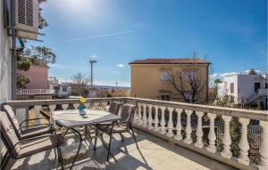 a patio with a table and chairs on a balcony at Gorgeous Home In Selce With Wifi in Selce