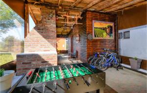 a outdoor kitchen with a poker table in a brick wall at Awesome Home In Jalzabet With Kitchen in Jalžabet +40 photos