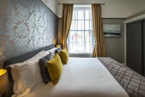 a bedroom with a bed with a large window at Gloucester House in Weymouth