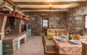 a kitchen and living room with a stone wall at Amazing Home In Skabici With 3 Bedrooms in Gromnik