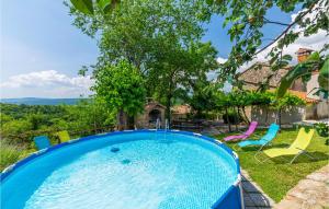 a swimming pool in the yard of a house at Amazing Home In Skabici With 3 Bedrooms in Gromnik