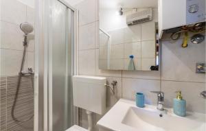 a bathroom with a toilet and a sink and a shower at 1 Bedroom Pet Friendly Home In Banjole in Banjole