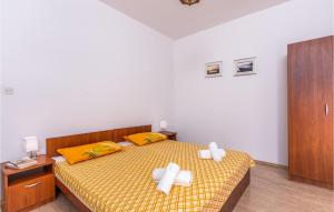a bedroom with a bed with two crosses on it at Gorgeous Apartment In Krk With Kitchen in Krk