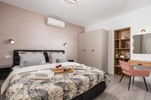 a bedroom with a large bed with a tray on it at Apartman Anja in Rijeka