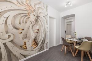 a dining room with a wall mural of a woman at Apartman Anja in Rijeka