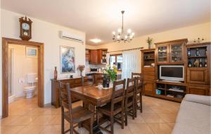 a dining room with a table and a television at Awesome Home In Orebic With Outdoor Swimming Pool in Orebić