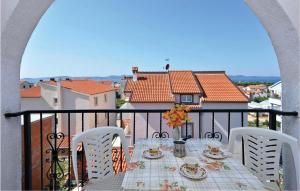 a table on a balcony with a view of a house at Beautiful Apartment In Zadar With 4 Bedrooms And Wifi in Zadar