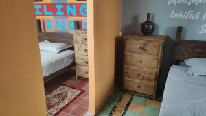 Postel nebo postele na pokoji v ubytování Chuchumbé Hotel & Hostal