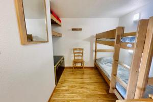 a room with two bunk beds and a chair at The climber at Chamrousse #CU in Chamrousse