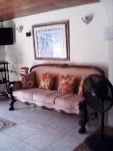 a living room with a couch with pillows on it at Castlevue B&B in Montego Bay