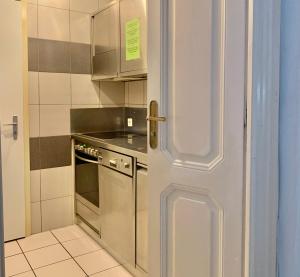 a door to a kitchen with a stove and a oven at Hotel&Hostel Montarina in Lugano