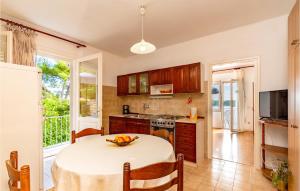 a kitchen with a table with a bowl of fruit on it at 2 Bedroom Beautiful Apartment In Blato in Prizba