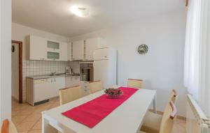 a kitchen with a table with a bowl of fruit on it at 3 Bedroom Gorgeous Home In Vinjani Gornji in Aračići